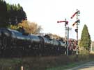 A down-bound freight train passes by the home signal.