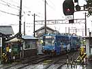 A light rail car leaving Kurono passing by a small signal box