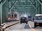 The Chikuma River is crossed by a great combined road and rail truss bridge