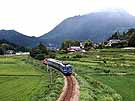 DE10-hauled series 12 coaches (train 4820) running in a lush landscape